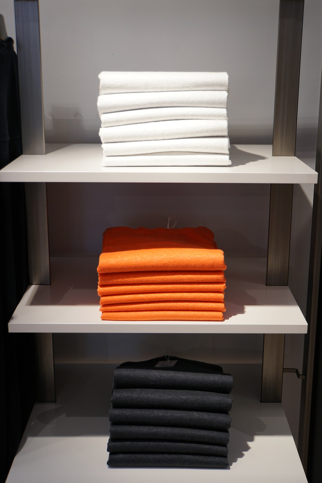 white and orange towels on white wooden shelf