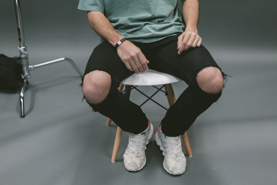 person sitting on white wooden stool