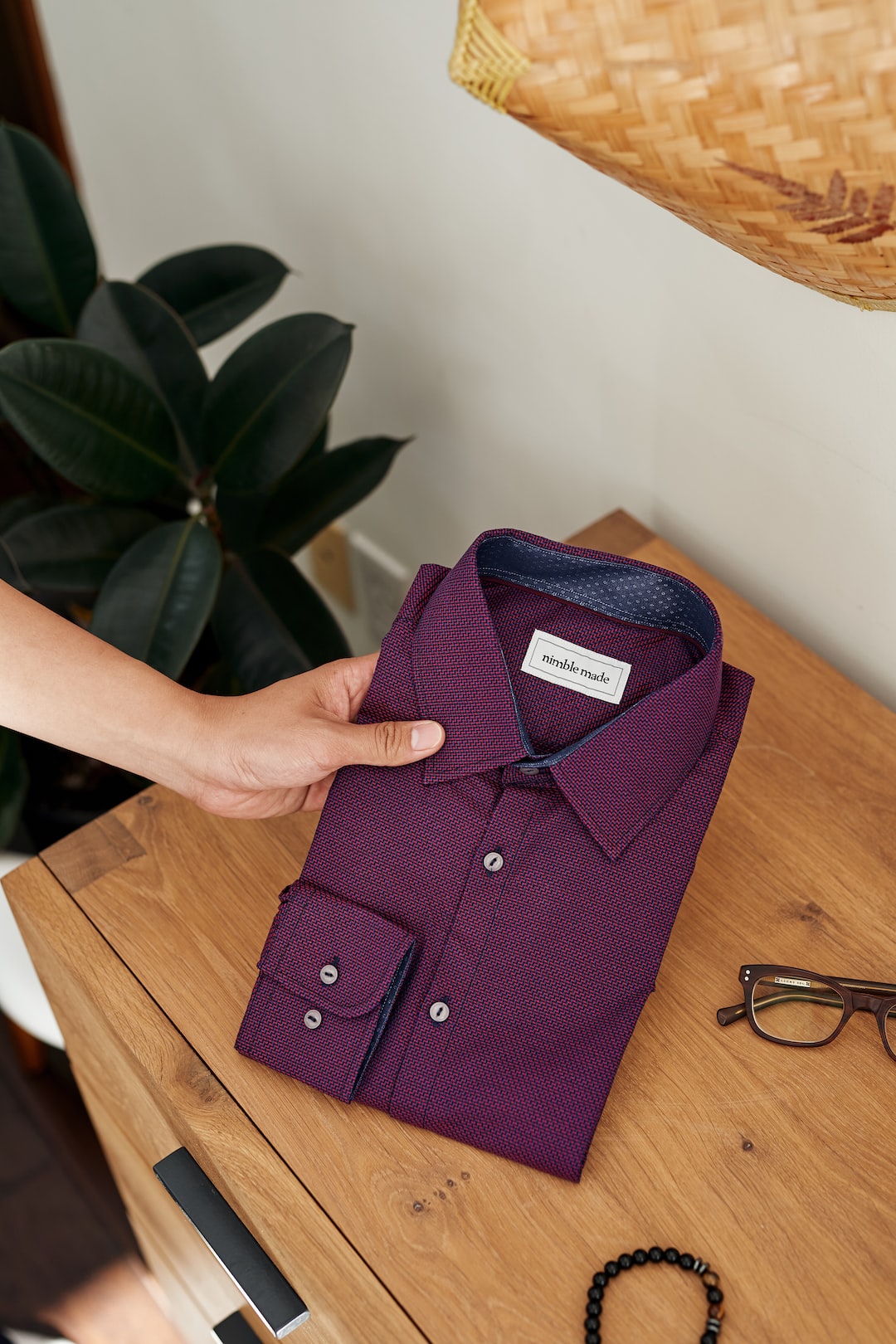 purple button up shirt on brown wooden table