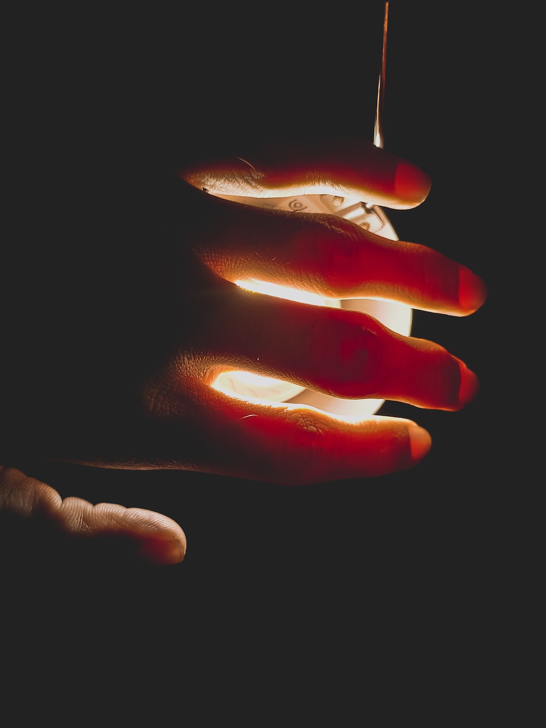 a person holding a lit object in their hand