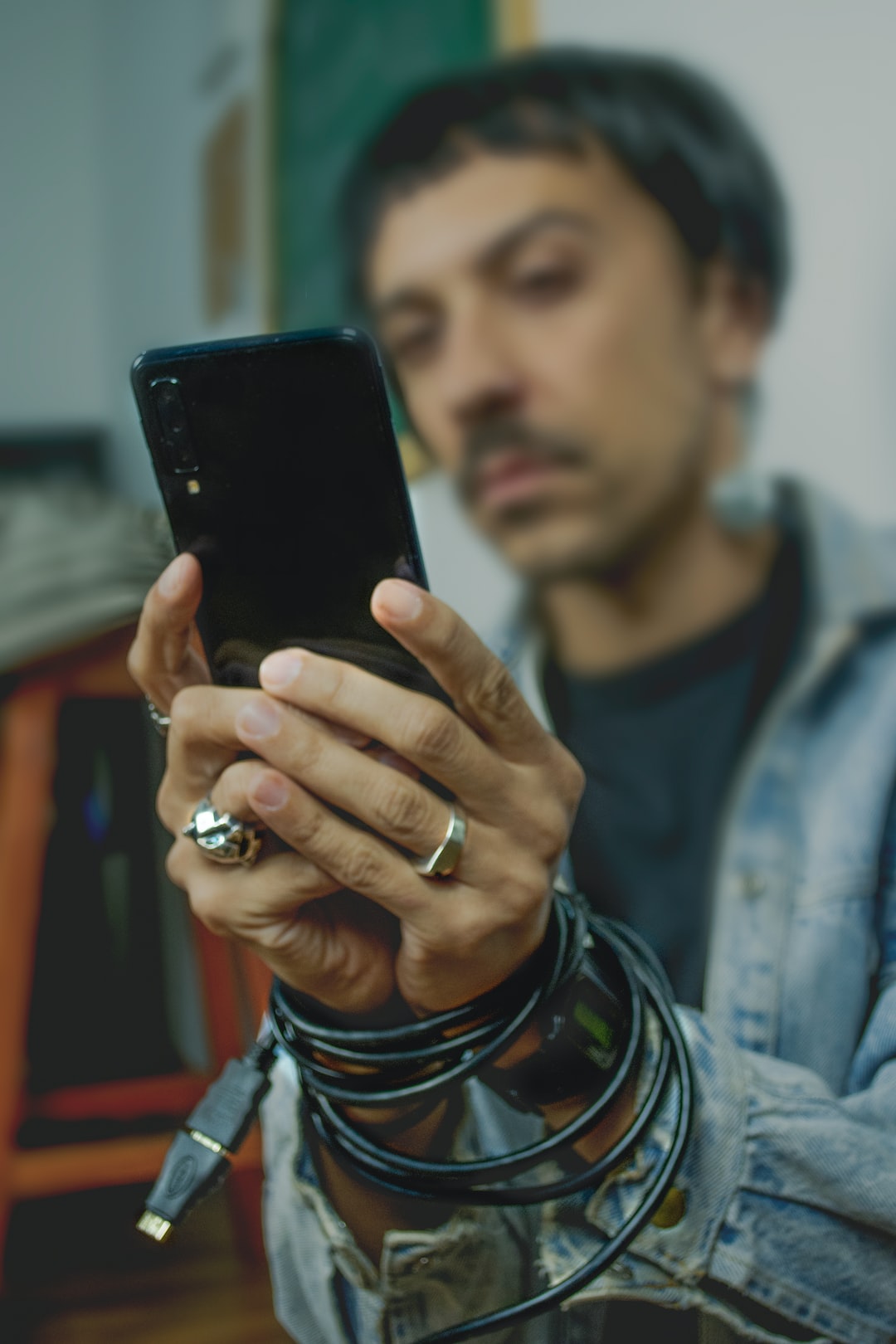 man holding black Android smartphone
