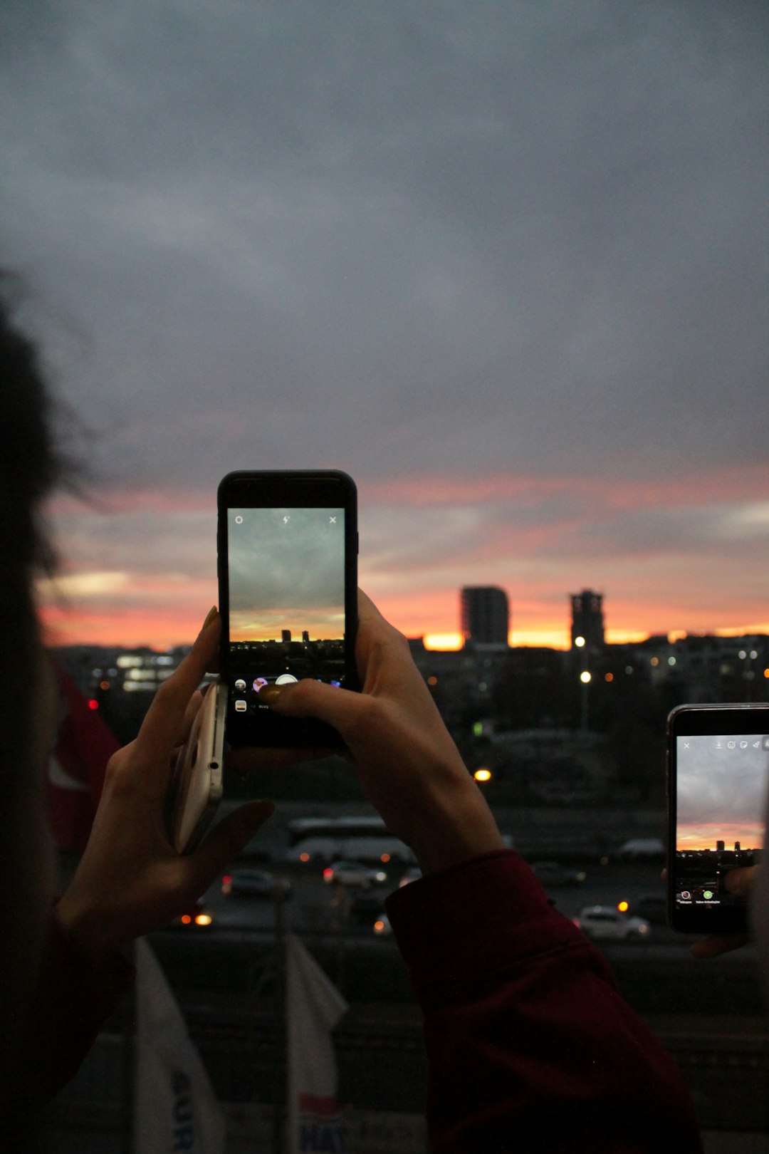 selective focus photography of person taking photo of city during golden hour